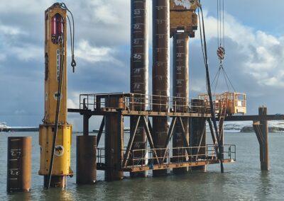 Image showing Watson & Hillhouse's PVE 82M vibratory hammer and BSP hydraulic hammer to install sheet piles and tube piles to create a Deep Water Terminal in Stornoway.