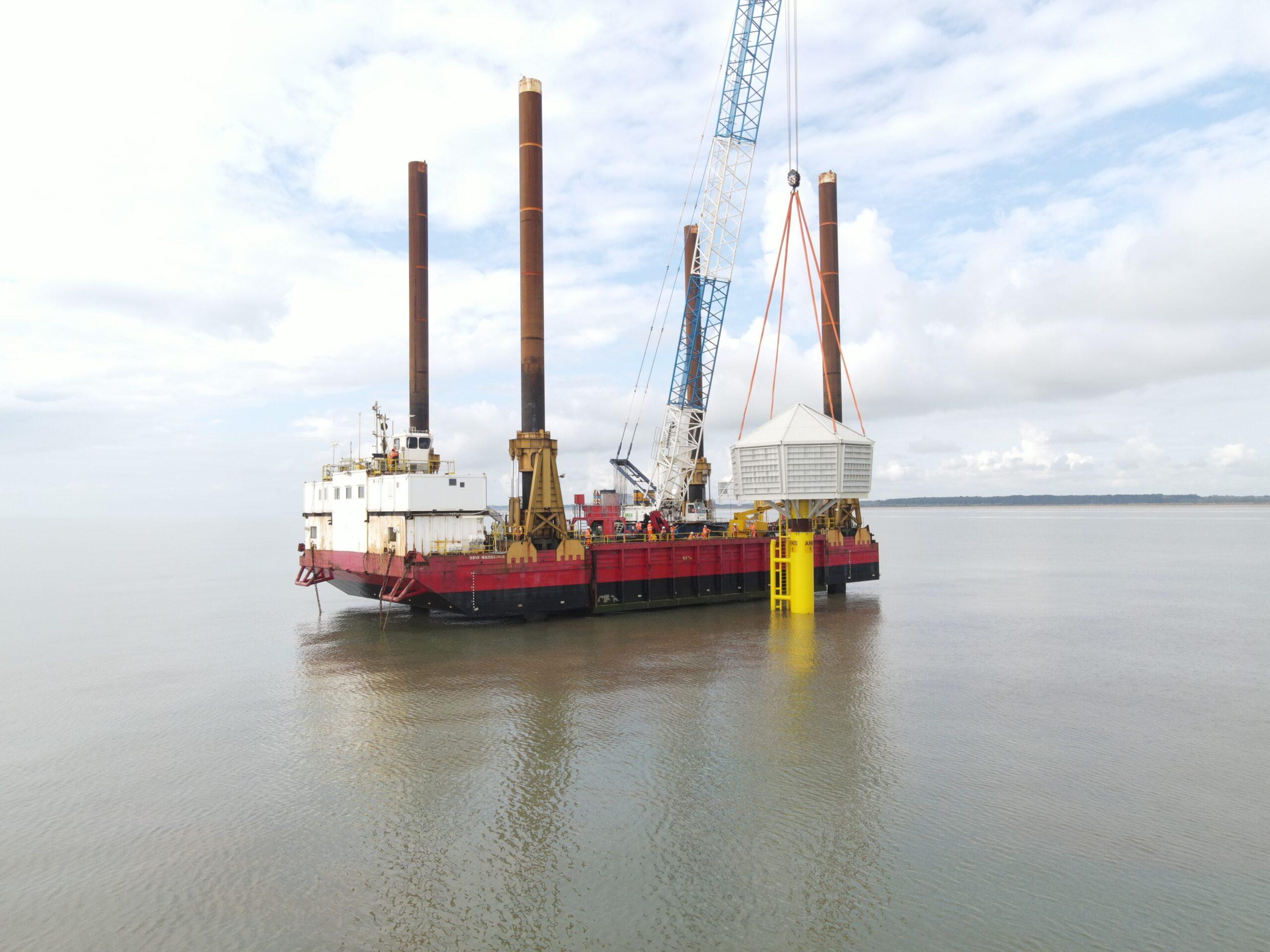 Image shows Red7Marine's jack-up barge and the top of a nearshore artificial nesting box being craned into position out at sea. The piles for the nesting box were driven using one of Watson & Hillhouse's PVE 40VM. The purpose of the nest boxes was to protect the Kittiwakes from the Hornsea Offshore Windfarm in East Anglia
