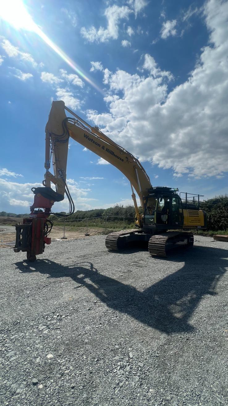 Image shows a Watson & Hillhouse branded excavator with a Movax SG-75V attached parked up ready to undertake cabling onshore for offshore windfarm in Norfolk.